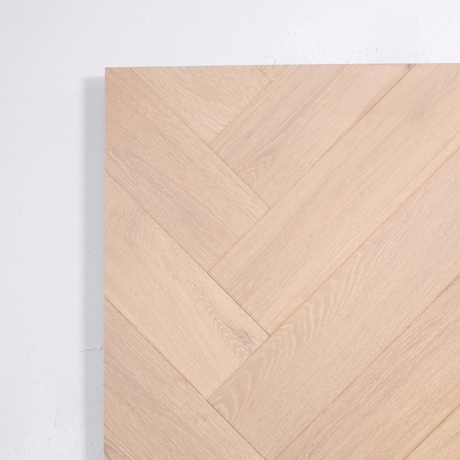 Flat lay of Natural Limed Engineered Timber Herringbone 15.3mm in Natural Limed colour warm tone herringbone flooring sample