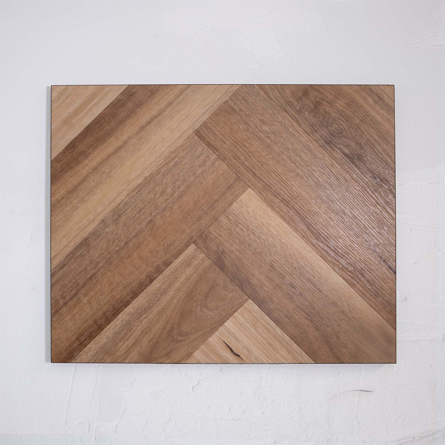 Close-up of Natural Spotted Gum SPC Hybrid Floorboards Herringbone 7.5+2mm in Natural Spotted colour warm tone herringbone flooring sample