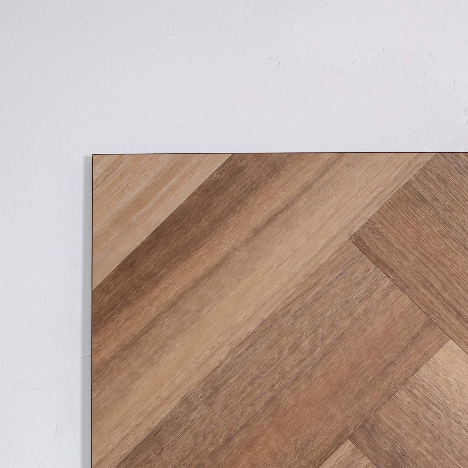Front view of Natural Spotted Gum SPC Hybrid Floorboards Herringbone 7.5+2mm in Natural Spotted colour warm tone herringbone flooring sample