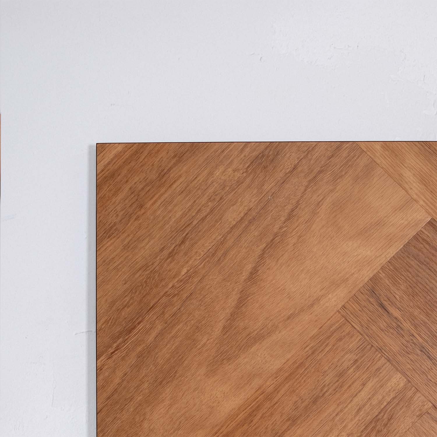 Perspective view of Pacific Spotted Gum SPC Hybrid Floorboards Herringbone 7.5+2mm in Pacific Spotted colour warm tone herringbone flooring sample